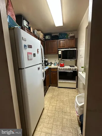 a white refrigerator freezer sitting inside of a kitchen