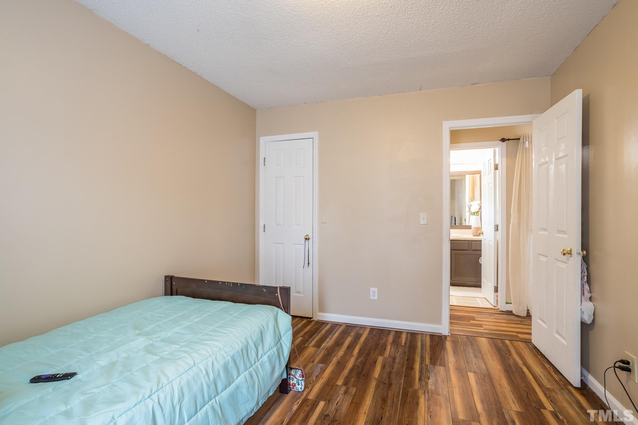 2109 Havering Place Raleigh, NC 27604 - Photo 34 of 35 a bedroom with a bed and wooden floor