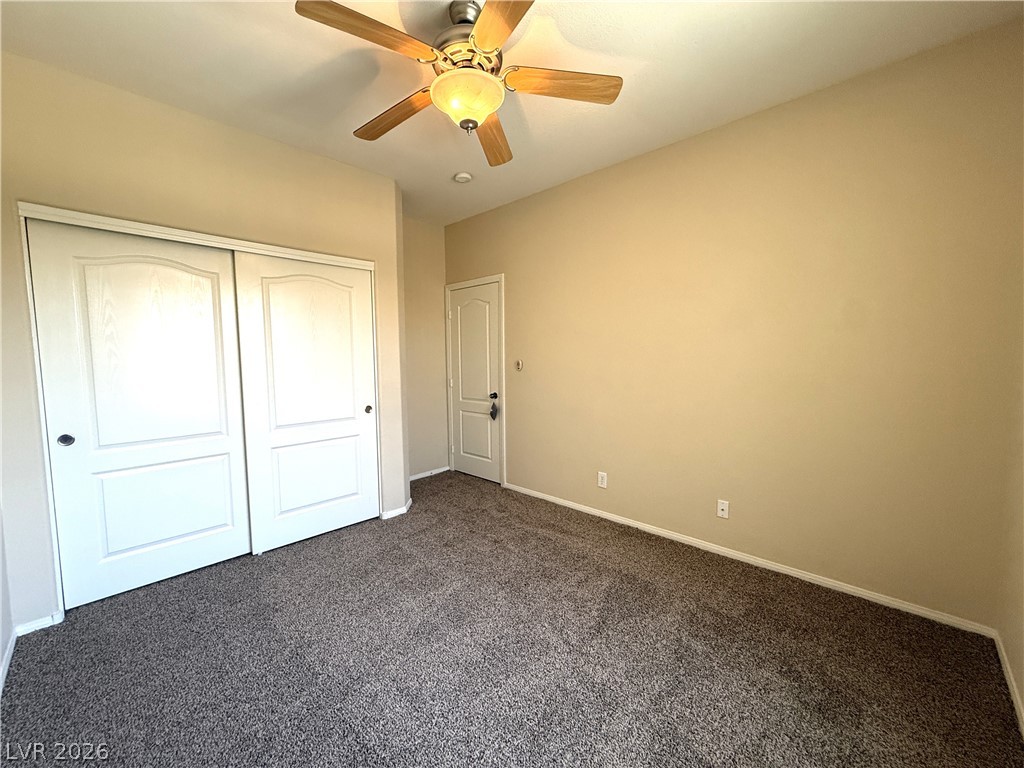 5942 Rampolla Drive Las Vegas, NV 89141 - Photo 20 of 27 A well-lit bedroom features plush carpeting and a convenient ceiling fan.
