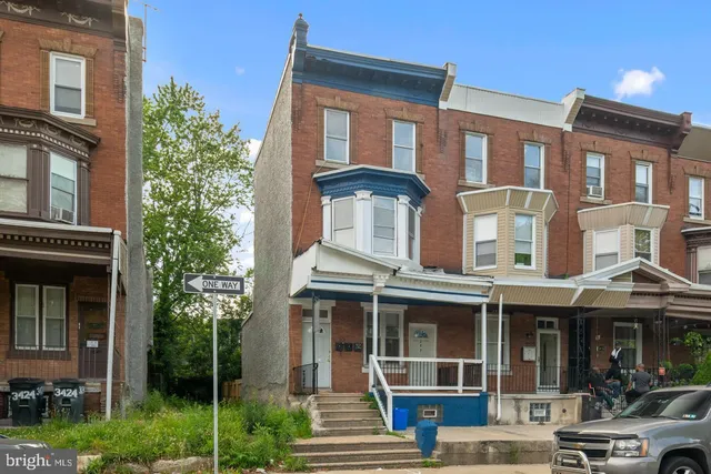 a front view of a residential apartment building with a yard