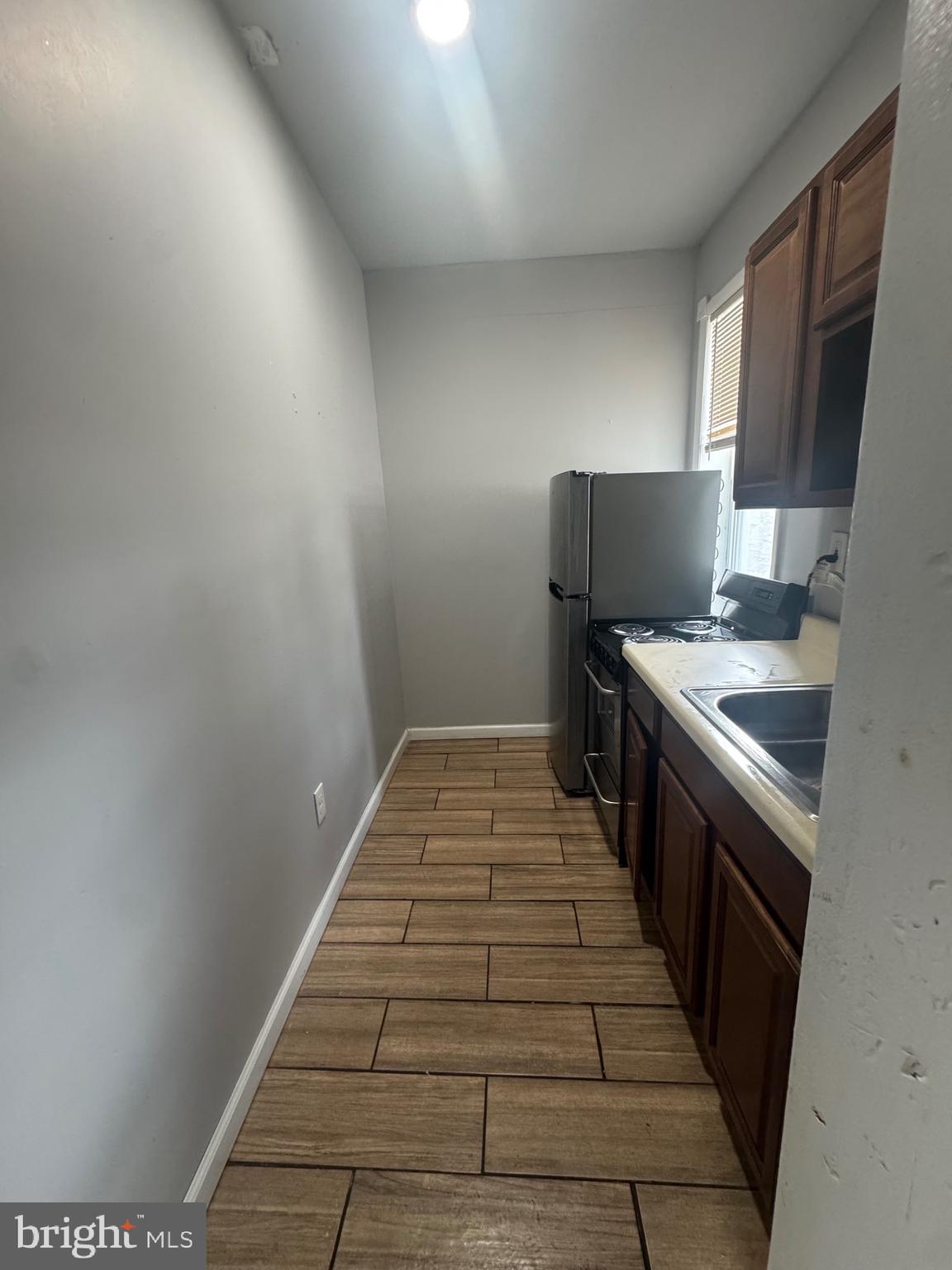3428 North 23rd Street, Unit 3 Philadelphia, PA 19140 - Photo 7 of 14 a kitchen with a sink and cabinets