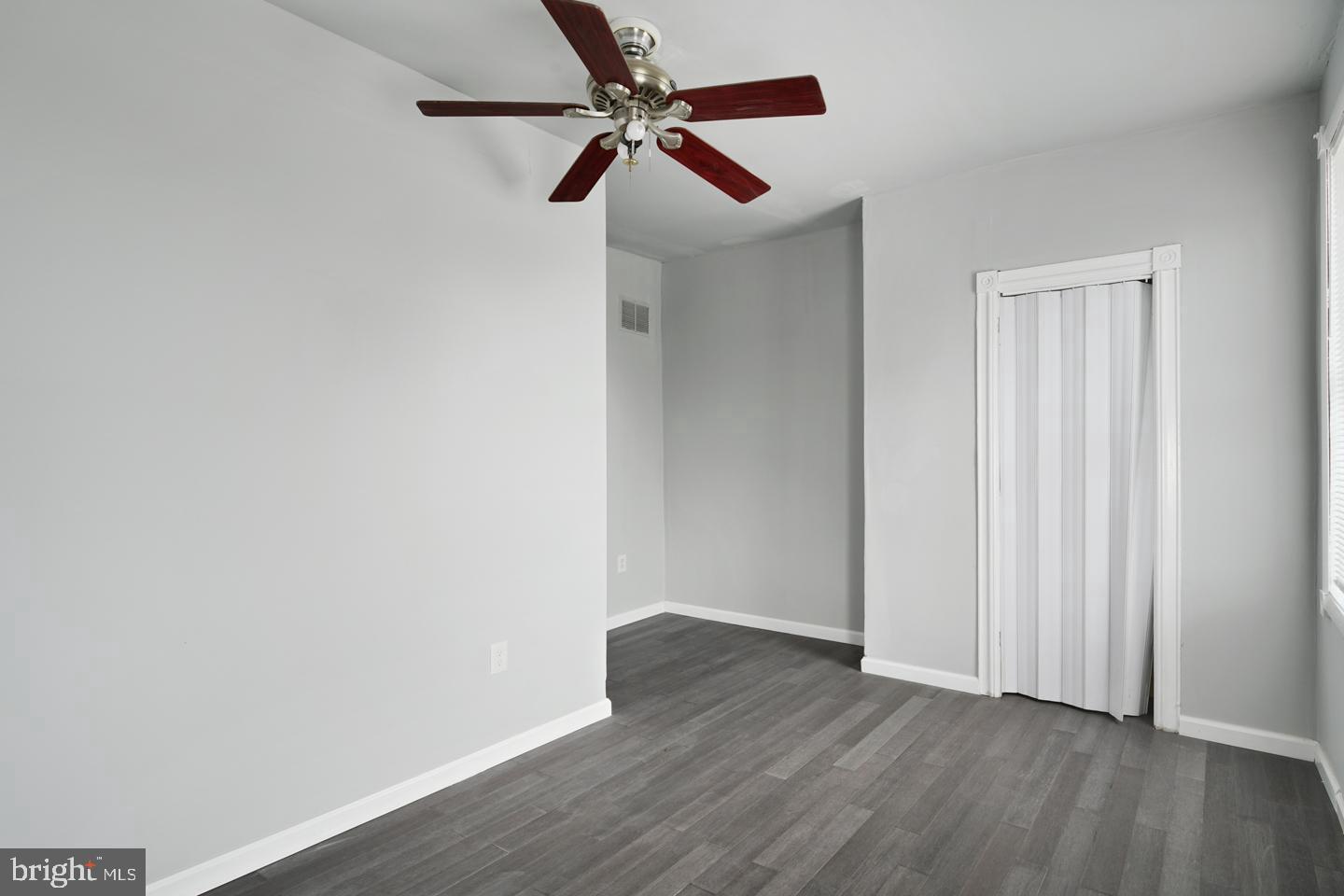 3428 North 23rd Street, Unit 3 Philadelphia, PA 19140 - Photo 9 of 14 an empty room with wooden floor fan and windows