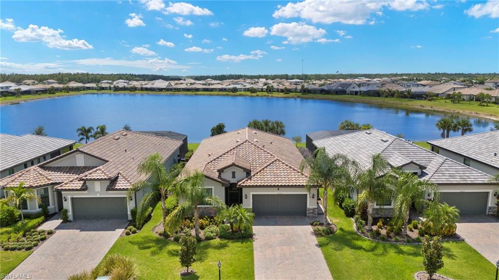 an aerial view of a house with a garden and lake view