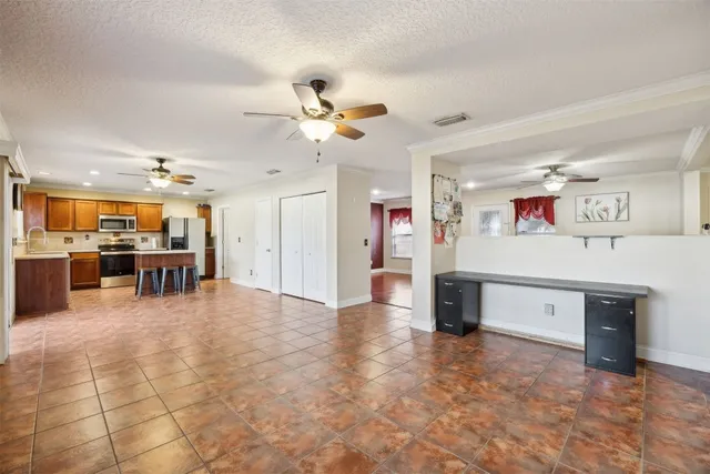 an empty room with closet and fan