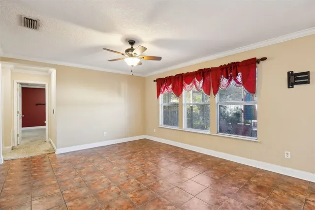 a view of livingroom with furniture chandelier fan and windows