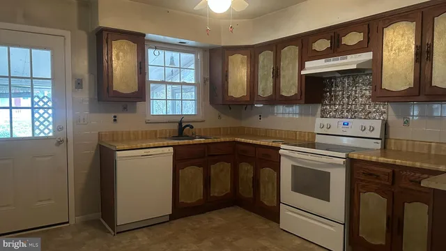 a kitchen that has a sink and a stove in it