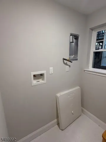 a large kitchen with stainless steel appliances granite countertop a stove a sink and a refrigerator