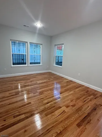 a view of a room with wooden floor