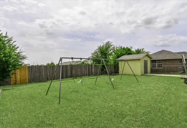 a view of backyard with trampoline
