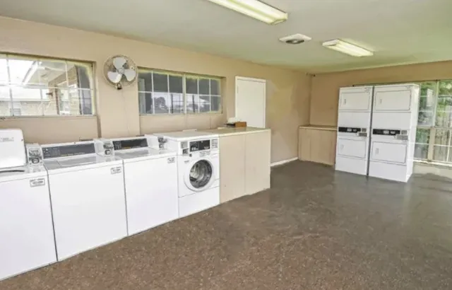 a kitchen with a stove a sink and a refrigerator