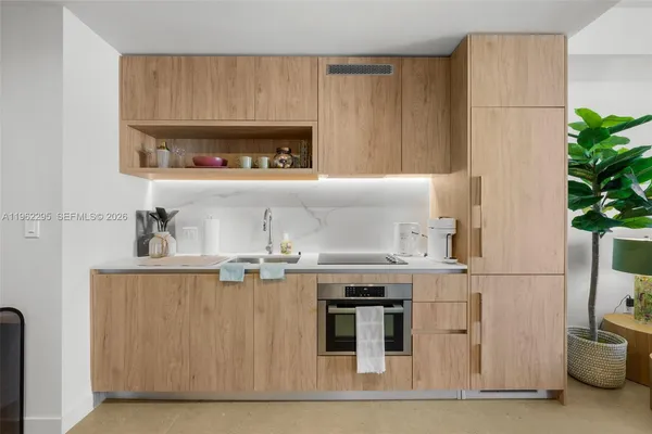 a kitchen with stainless steel appliances granite countertop a sink and a refrigerator