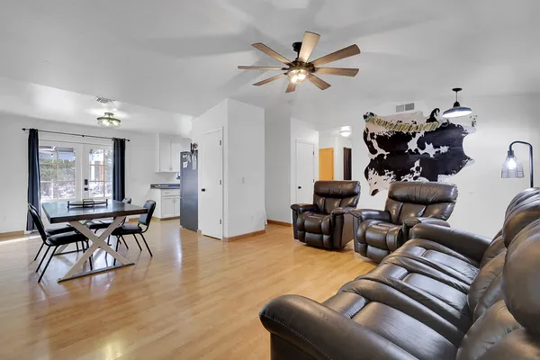 a living room with furniture and wooden floor