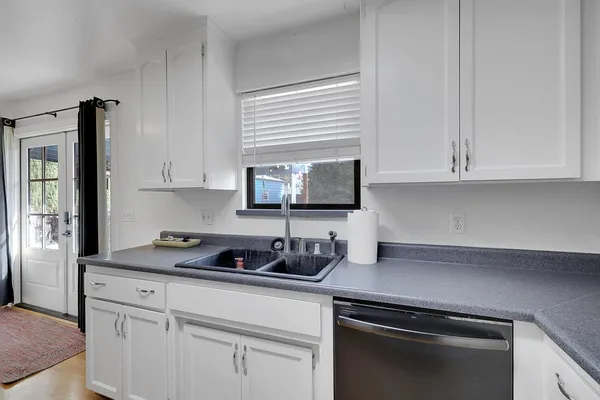a kitchen with appliances a sink and cabinets