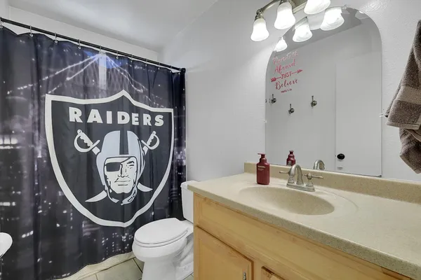 a bathroom with a toilet a sink and a mirror