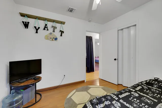 a bedroom with a bed and a flat screen tv