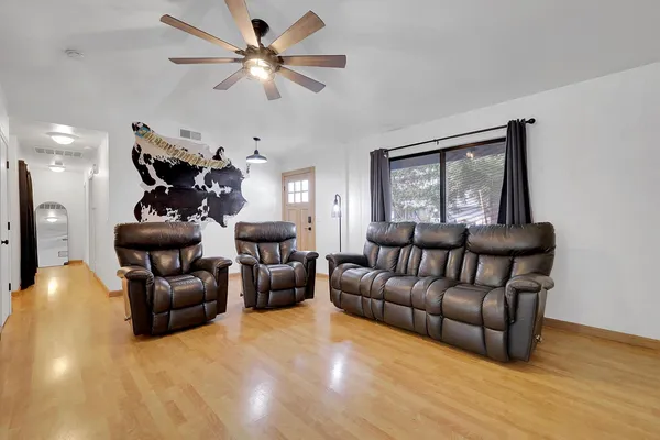 a living room with furniture and wooden floor