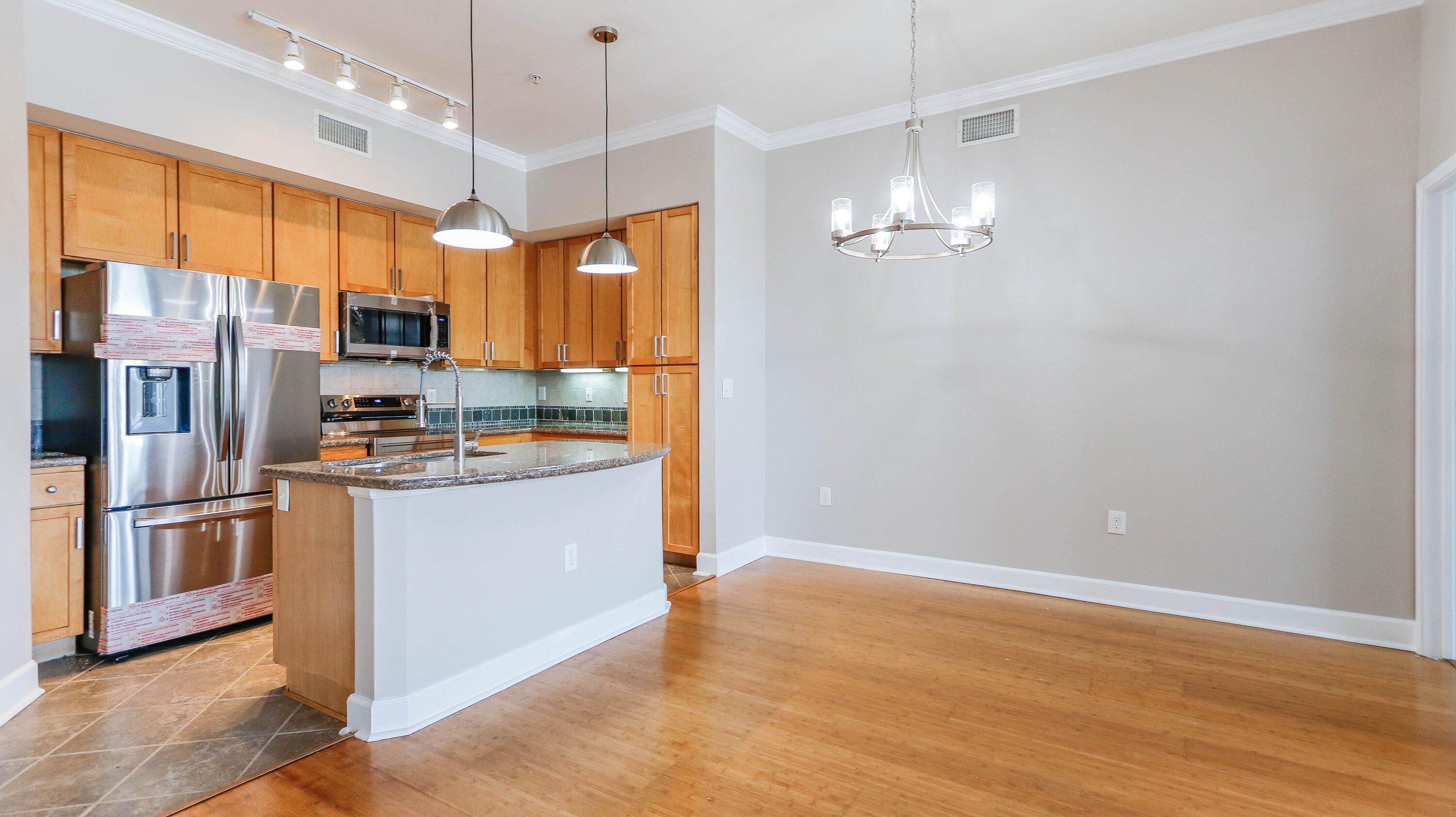 8700 Front Beach Road, Unit 1311 Panama City Beach, FL 32407 - Photo 12 of 65 a kitchen with stainless steel appliances granite countertop a refrigerator a oven and a refrigerator
