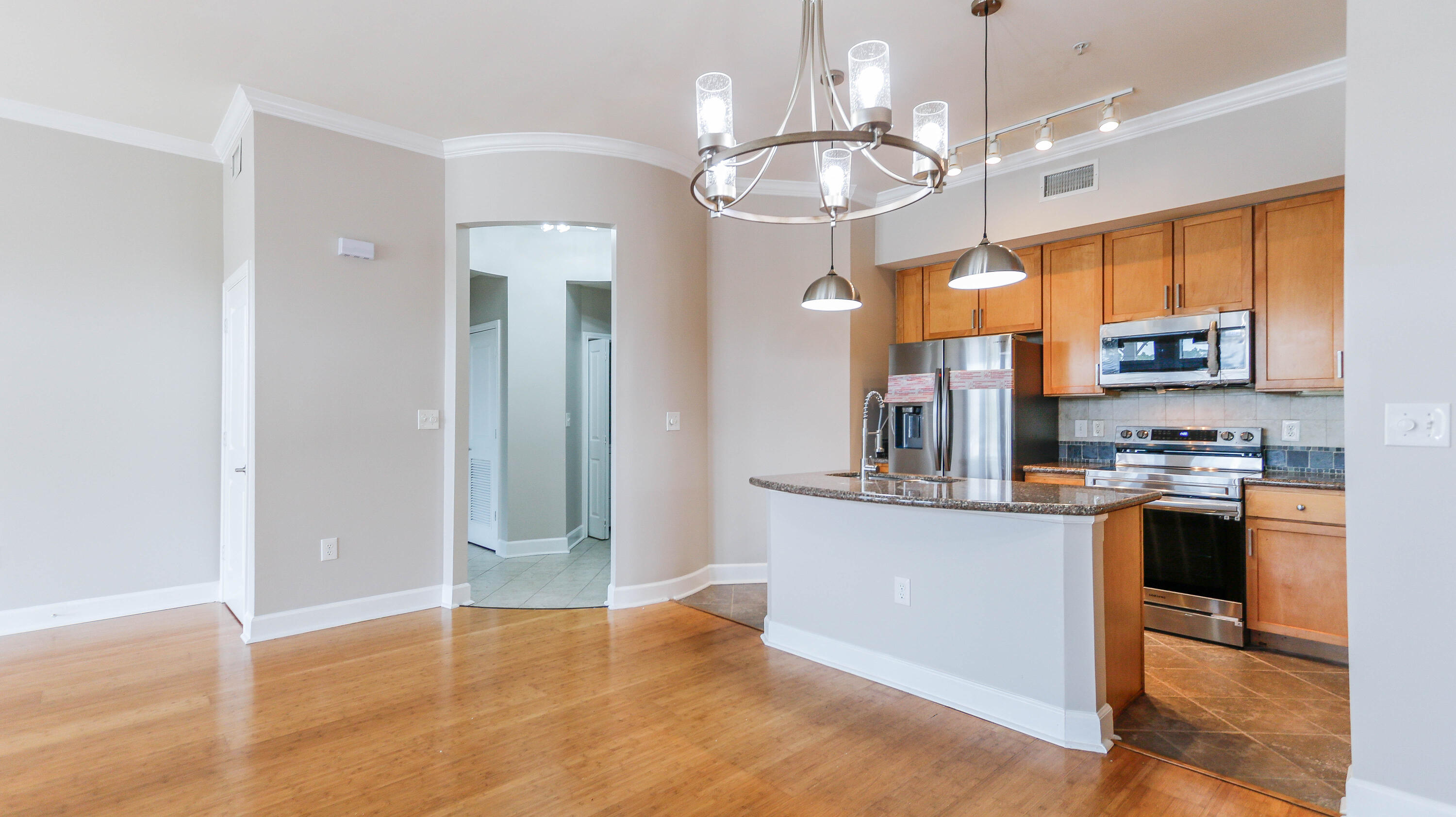 8700 Front Beach Road, Unit 1311 Panama City Beach, FL 32407 - Photo 13 of 65 a view of a kitchen with stainless steel appliances granite countertop a refrigerator and microwave