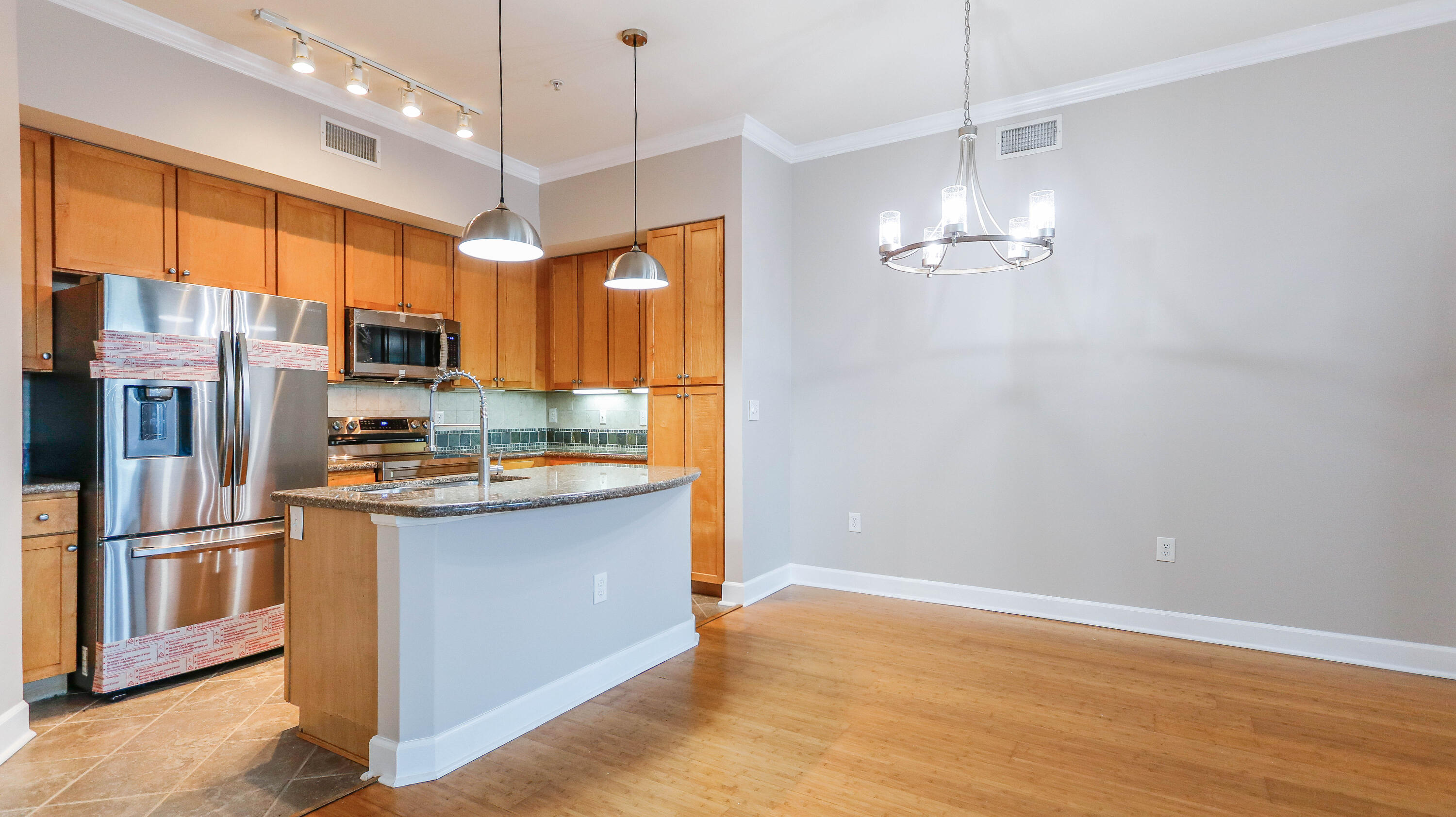 8700 Front Beach Road, Unit 1311 Panama City Beach, FL 32407 - Photo 19 of 65 a kitchen with stainless steel appliances granite countertop a refrigerator a oven a sink and a refrigerator