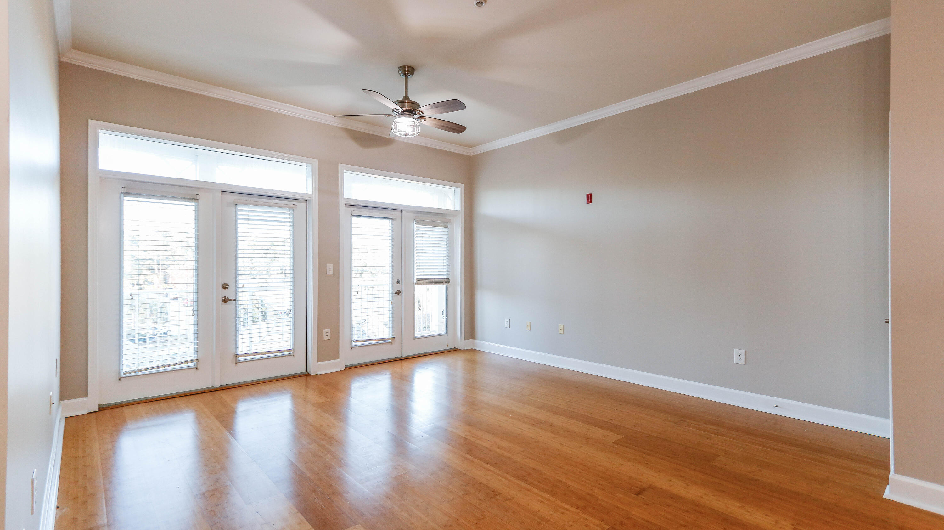 8700 Front Beach Road, Unit 1311 Panama City Beach, FL 32407 - Photo 26 of 65 a view of an empty room with wooden floor and a window