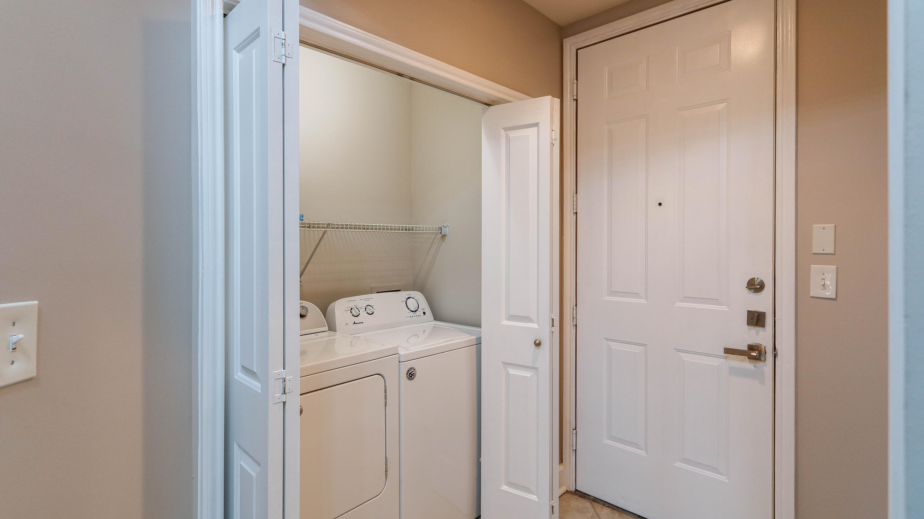 8700 Front Beach Road, Unit 1311 Panama City Beach, FL 32407 - Photo 30 of 65 a utility room with dryer and washer