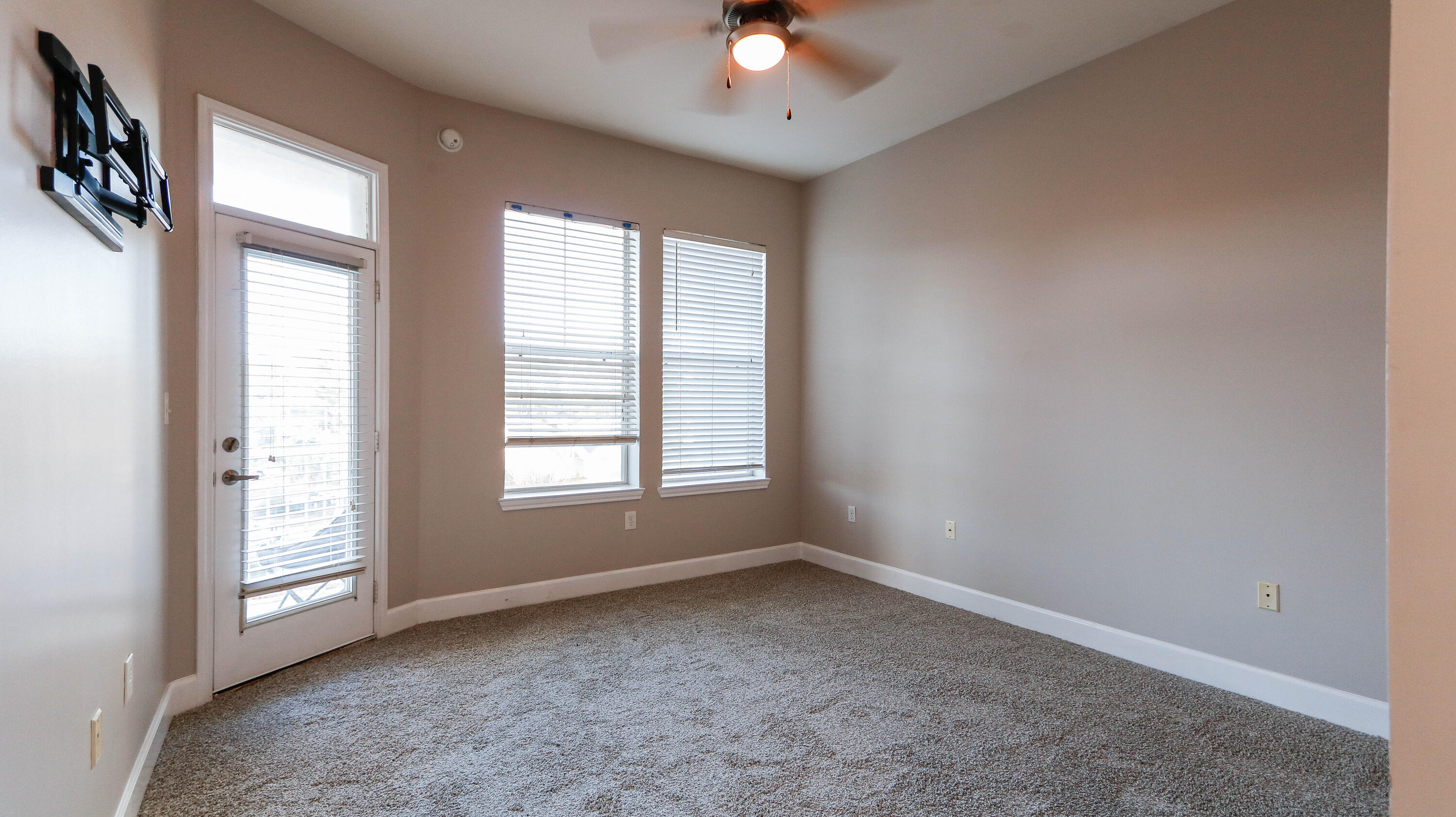 8700 Front Beach Road, Unit 1311 Panama City Beach, FL 32407 - Photo 33 of 65 an empty room with windows and ceiling fan