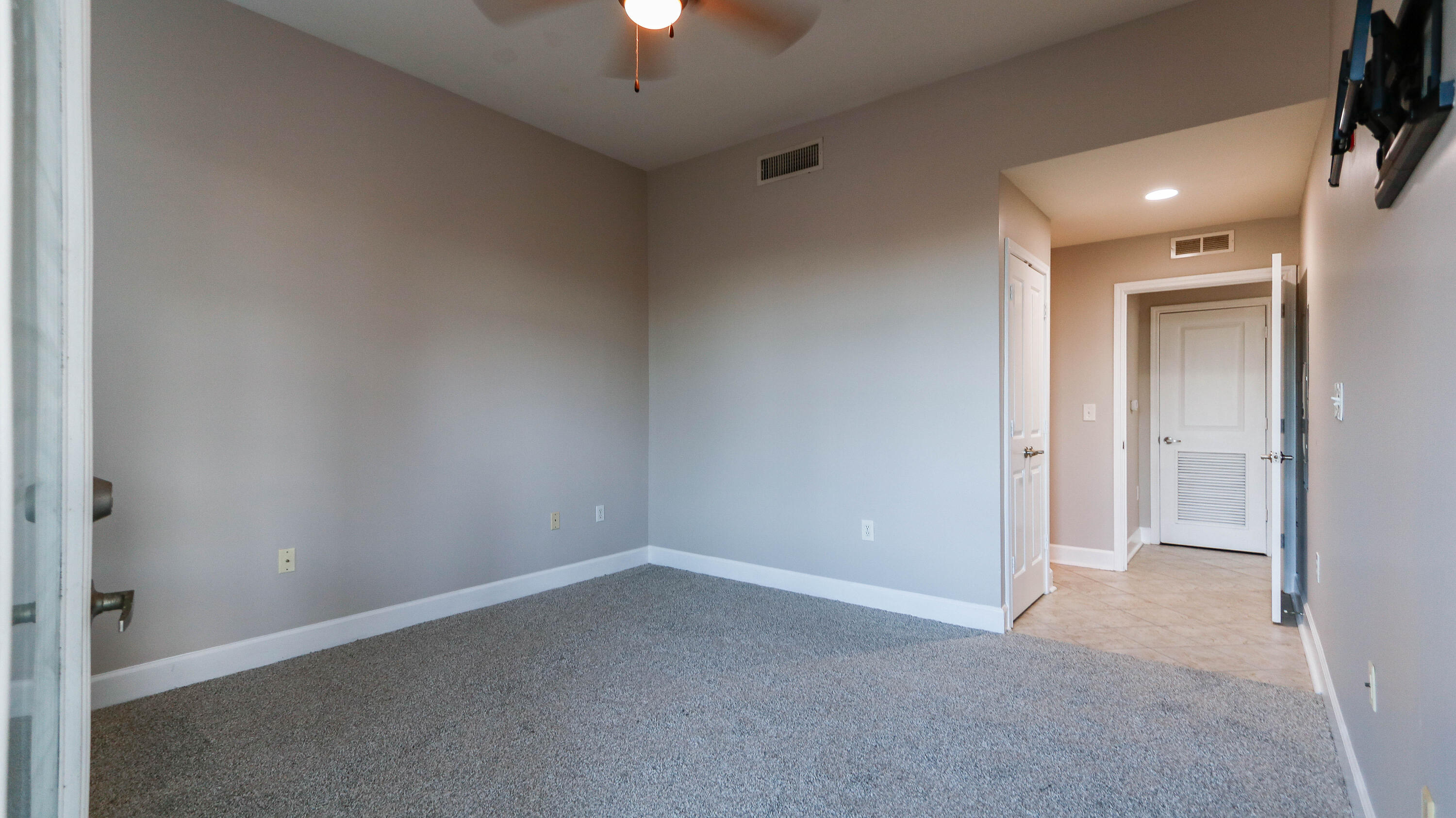 8700 Front Beach Road, Unit 1311 Panama City Beach, FL 32407 - Photo 34 of 65 an empty room with a empty space and a ceiling fan
