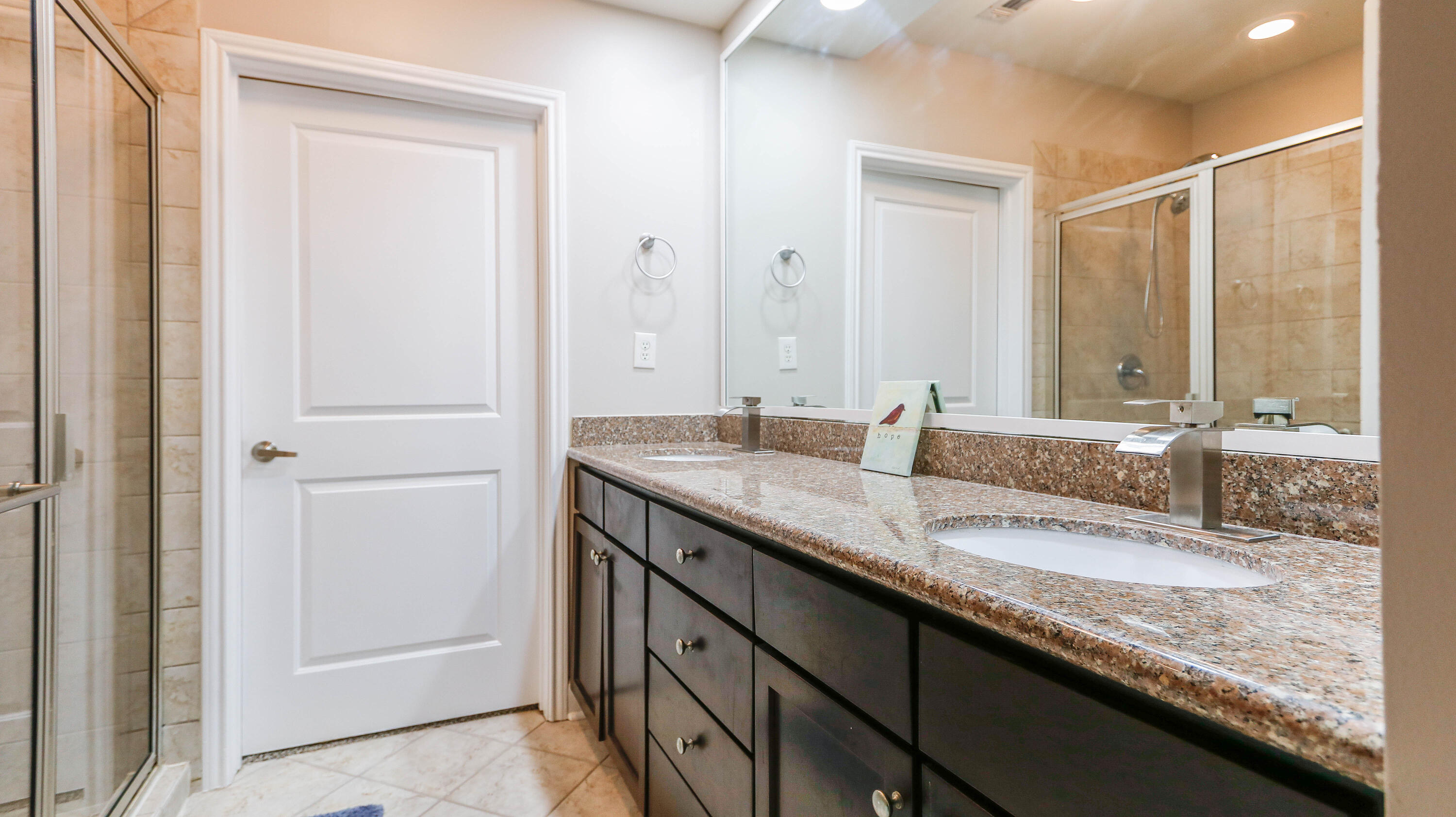 8700 Front Beach Road, Unit 1311 Panama City Beach, FL 32407 - Photo 35 of 65 a bathroom with a granite countertop sink and a mirror