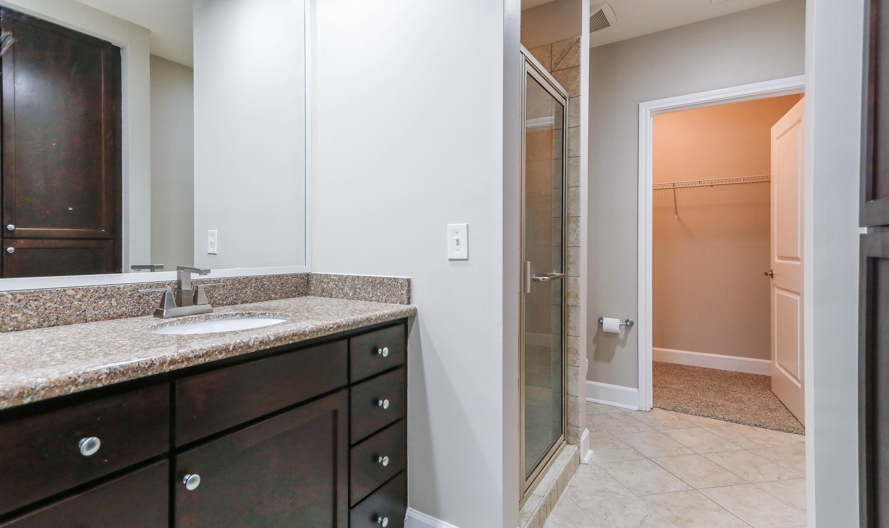 8700 Front Beach Road, Unit 1311 Panama City Beach, FL 32407 - Photo 44 of 65 a bathroom with a granite countertop sink and a mirror