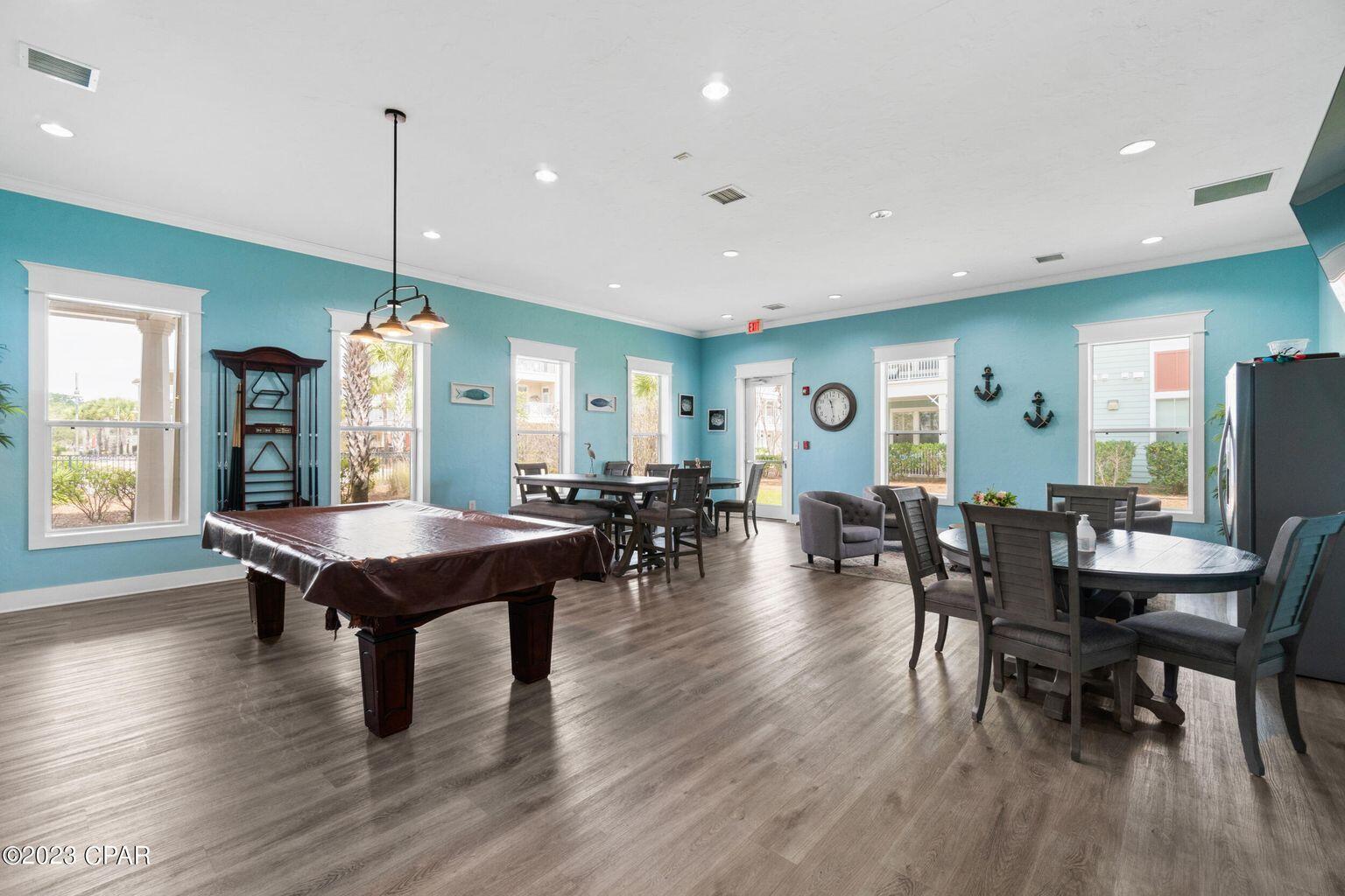 8700 Front Beach Road, Unit 1311 Panama City Beach, FL 32407 - Photo 57 of 65 a view of a dining room with furniture window and wooden floor