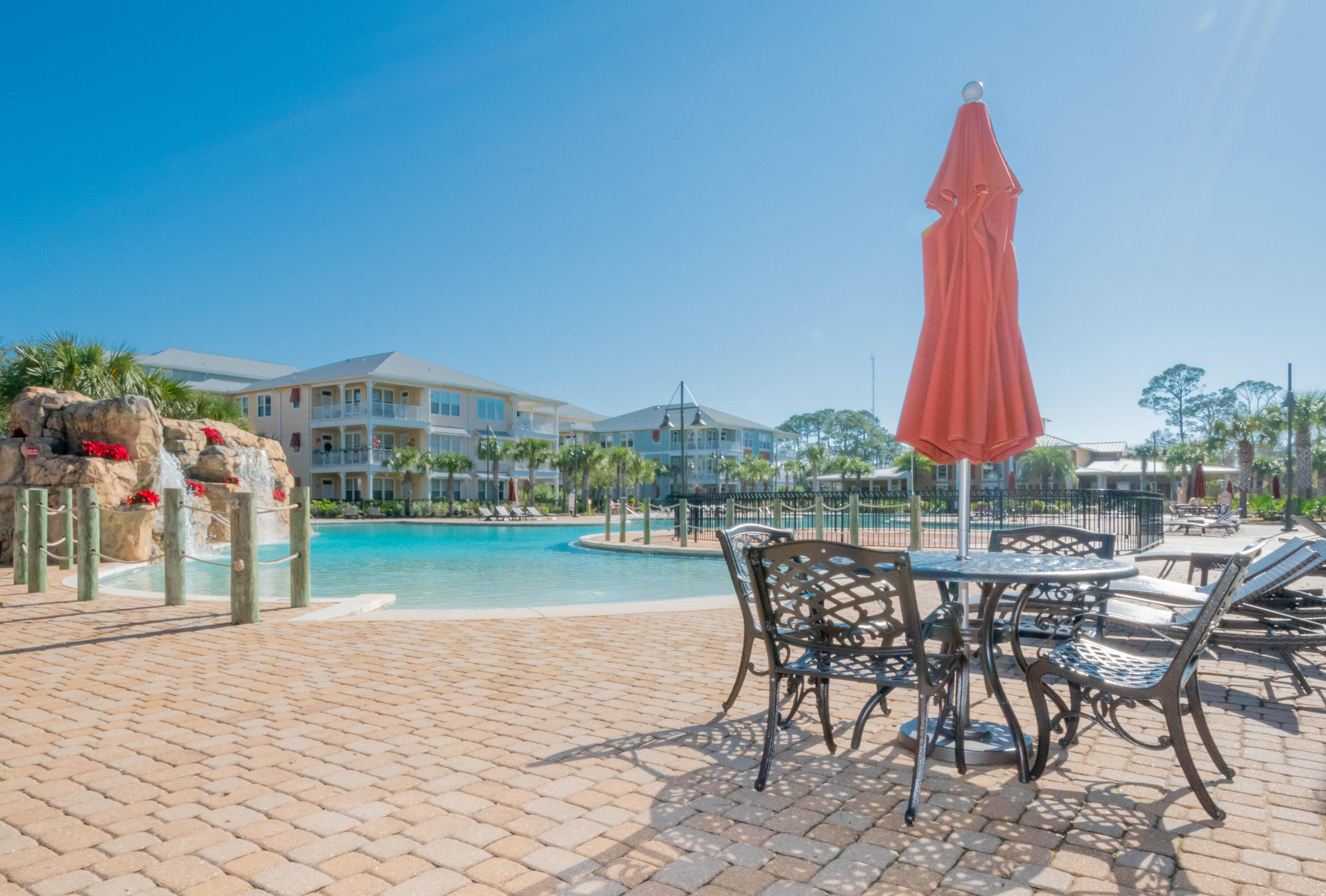 8700 Front Beach Road, Unit 1311 Panama City Beach, FL 32407 - Photo 61 of 65 a view of a swimming pool with a table and chairs