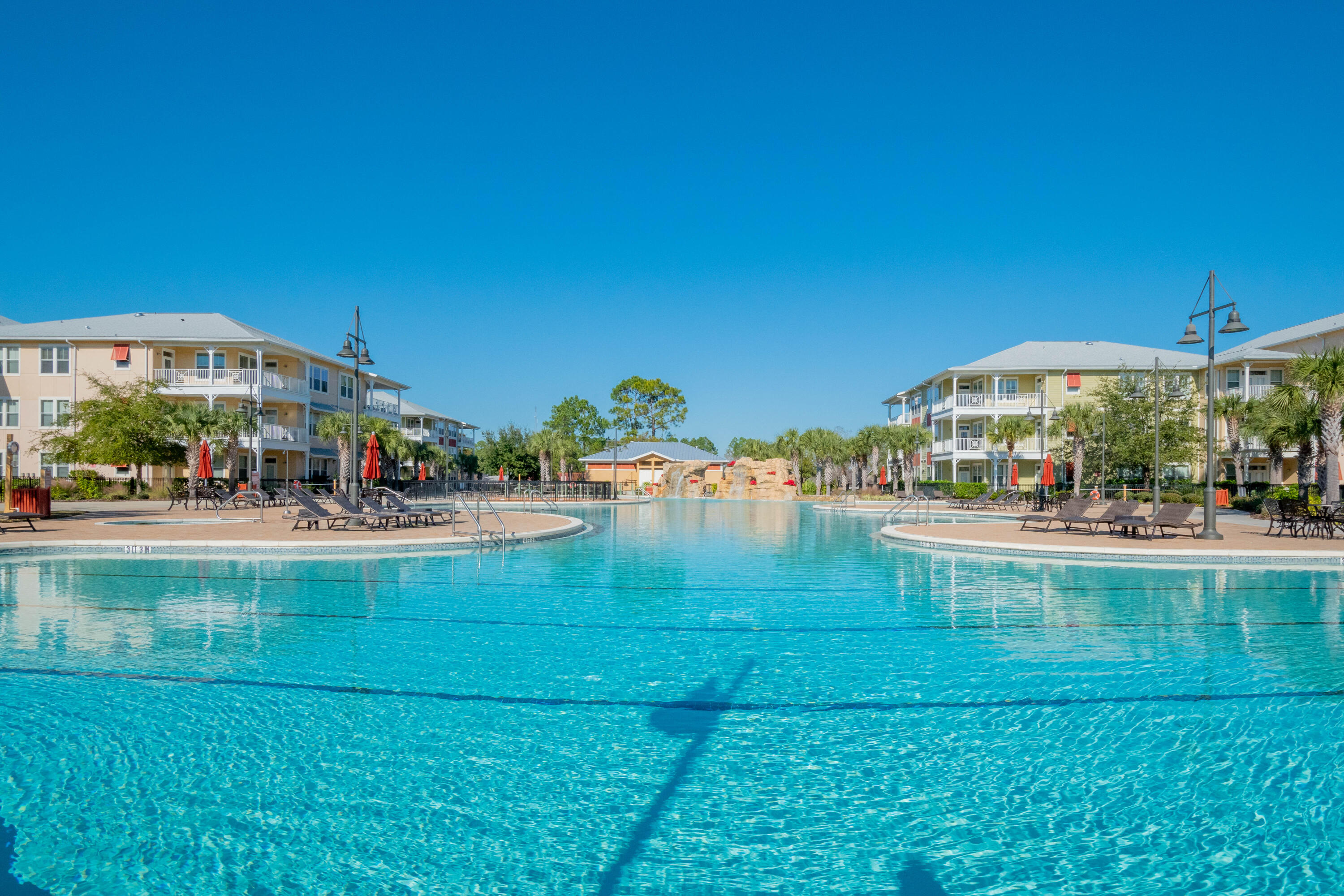 8700 Front Beach Road, Unit 1311 Panama City Beach, FL 32407 - Photo 63 of 65 a view of swimming pool with lawn chairs and large trees