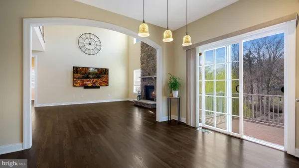 a view of a livingroom with furniture wooden floor and a chandelier