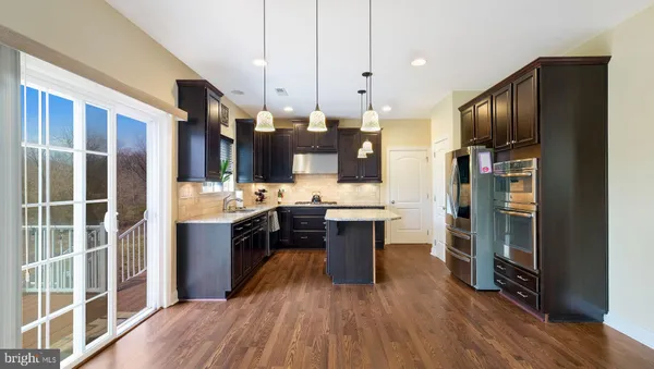 a large kitchen with a large counter top appliances and cabinets