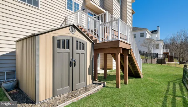 a view of a house with backyard and white walls