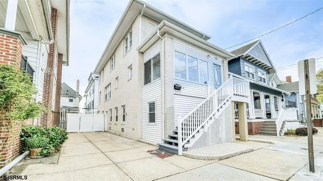 a view of a building with a small yard