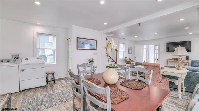 a view of a dining room with furniture and wooden floor
