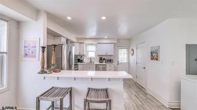 a kitchen with stainless steel appliances kitchen island granite countertop a sink and cabinets