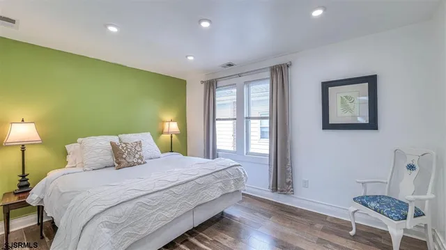 a bedroom with a bed and a chair