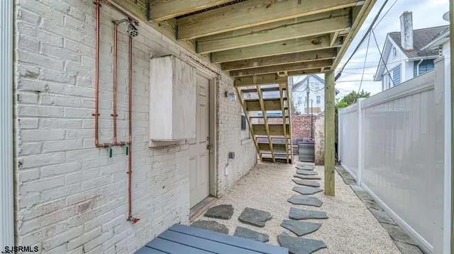 a view of walk in closet with wooden floor and a cabinet