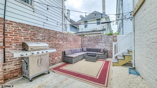 a view of a patio with a table and chairs