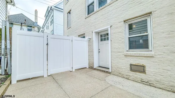 a view of a house with white door and a door