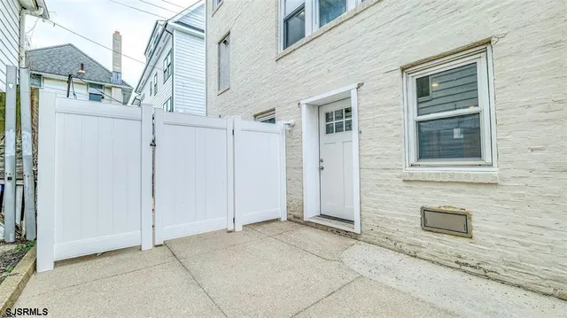 a view of a house with white door and a door