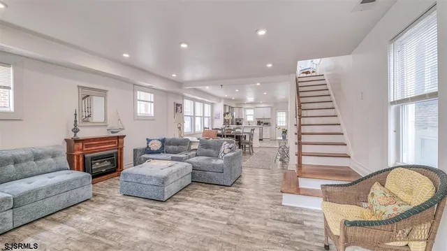 a living room with furniture a fireplace and a window