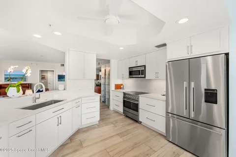 a large bathroom with a large mirror vanity and a shower