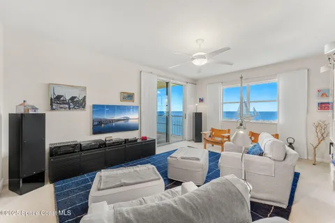 a view of a hallway with wooden floor and a living room