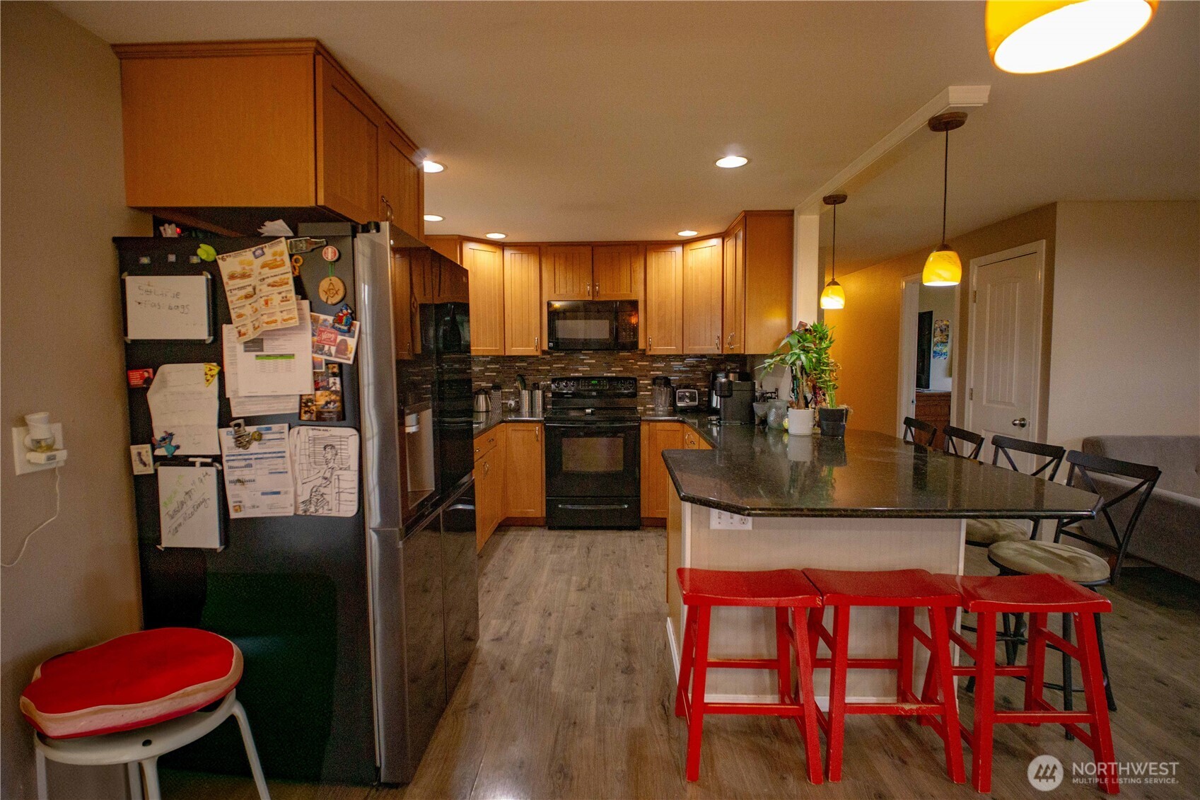 151 Valley View Drive Sequim, WA 98382 - Photo 11 of 40 a kitchen with stainless steel appliances granite countertop a refrigerator a stove and a sink with wooden floor
