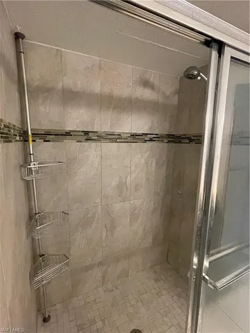 a bathroom with a glass shower door