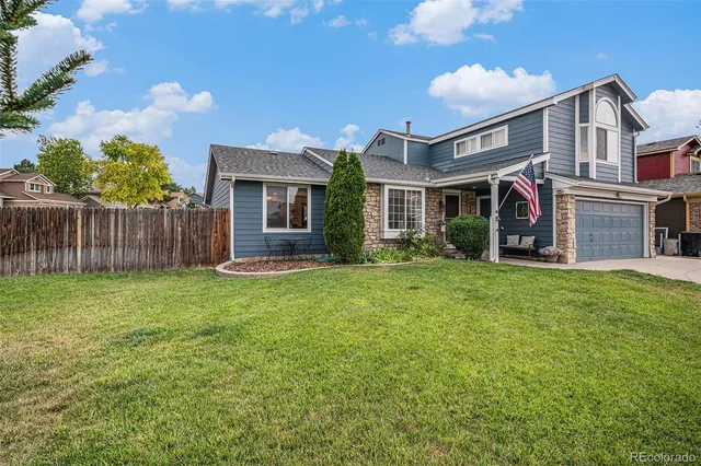 a view of a house with a yard and plants