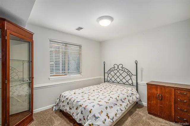 a bedroom with a large bed and a dresser